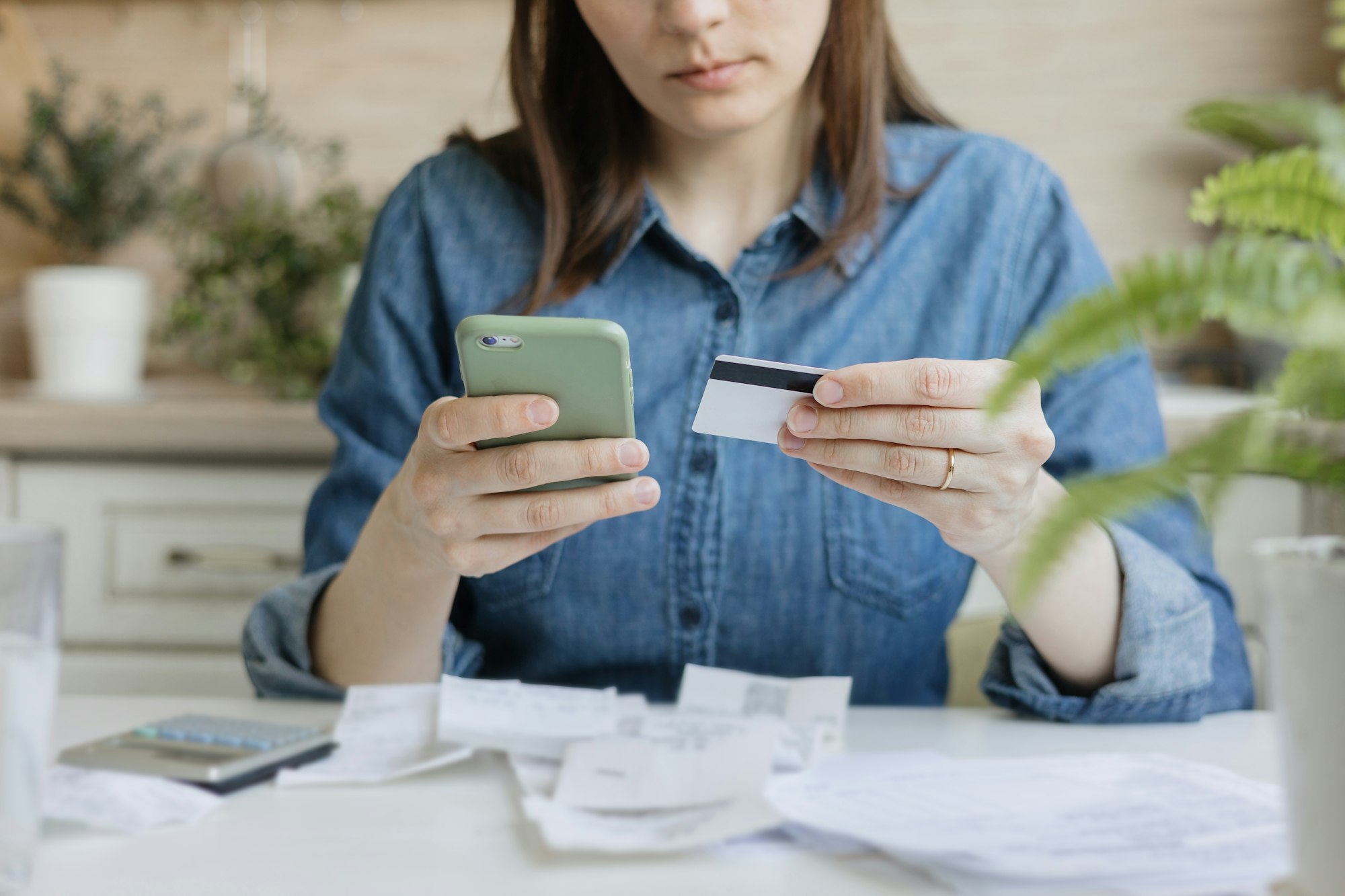 financial literacy and loan repayment. a woman calculates on a calculator the amount of monetary inc